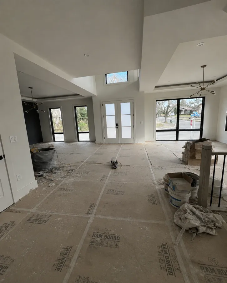 A dusty house with a white door and unclean floor
