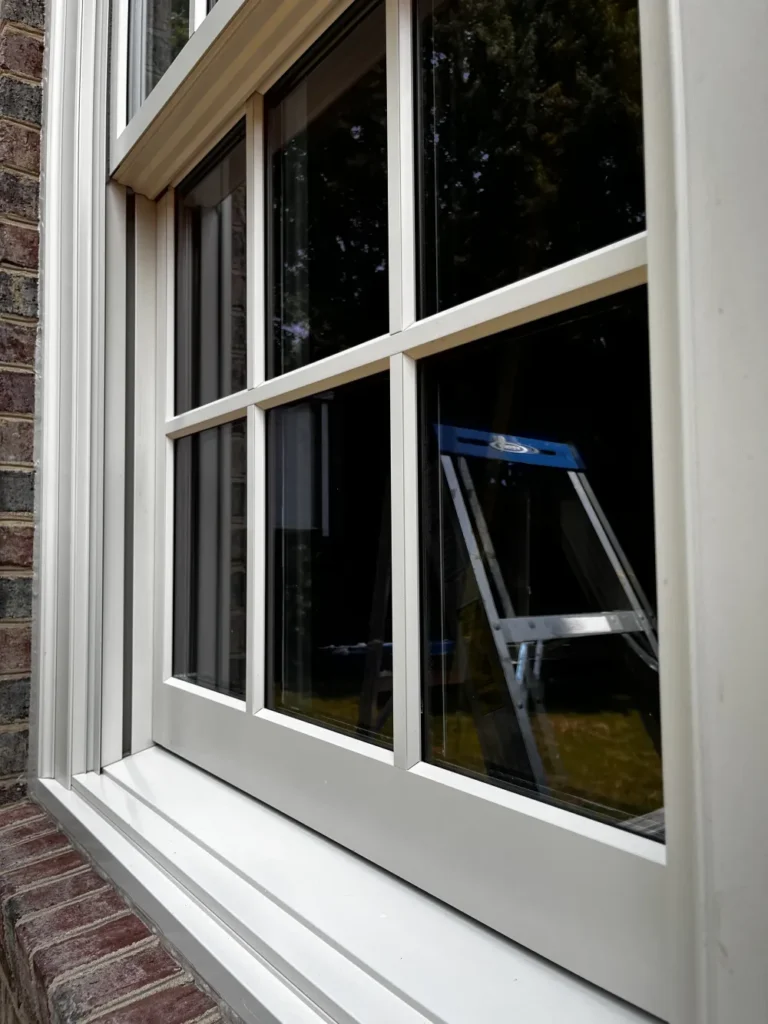 Close-up of a streak-free multi-pane window exterior set in a brick wall, cleaned to perfection by L&V Cleaning.